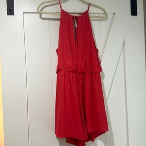 Red romper with open V cut neck and snatched waist